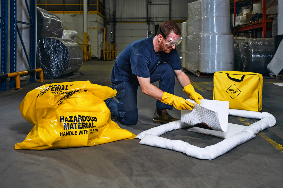 Technician laying out socks and pads from a GreenStrength spill kit