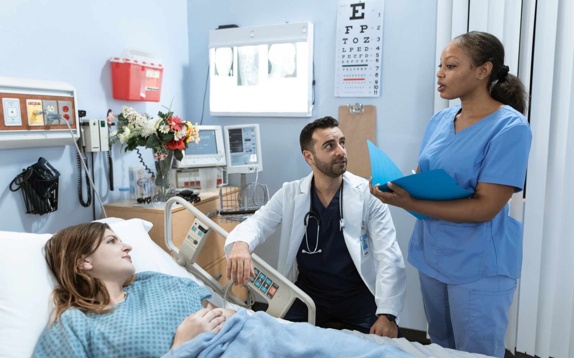 Clinician with a patient in a hospital room